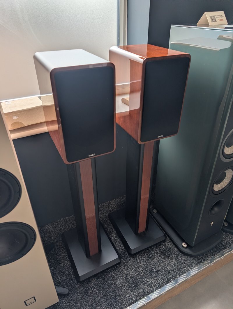 Acoustic Energy AE1 Active Speakers Piano Walnut Gloss (Pair) front angle with reference stands