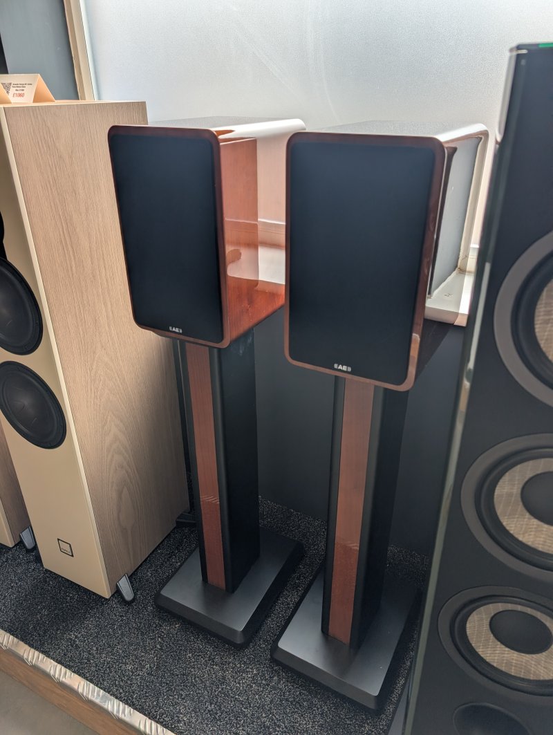 Acoustic Energy AE1 Active Speakers Piano Walnut Gloss (Pair) front right angle with reference stands