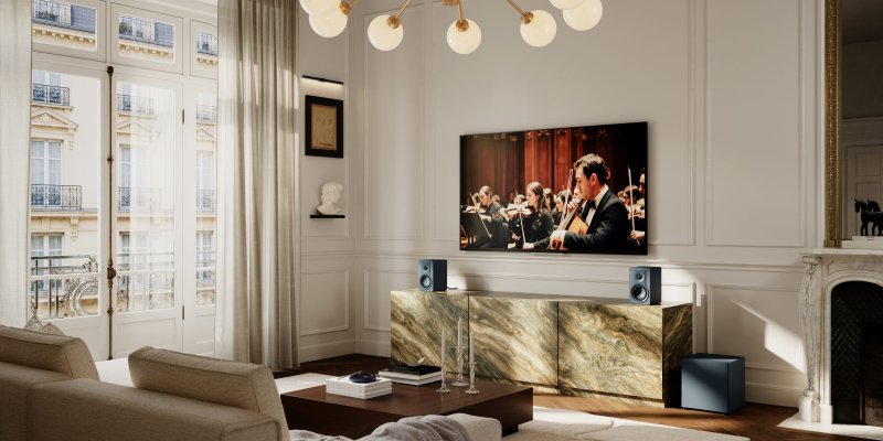 DALI BASIK SUB in Chilly Blue in a living room with bookshelf speakers
