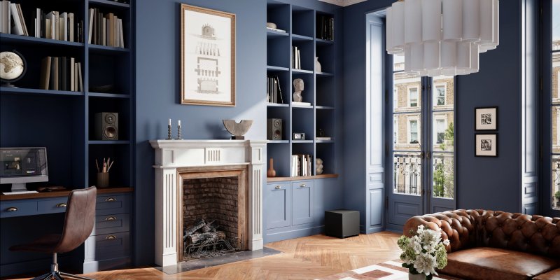 DALI BASIK SUB in Solid Black in a living room with bookshelf speakers