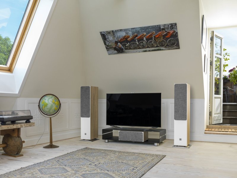 DALI Oberon 7 Light Oak speakers in a living room stereo system with grilles
