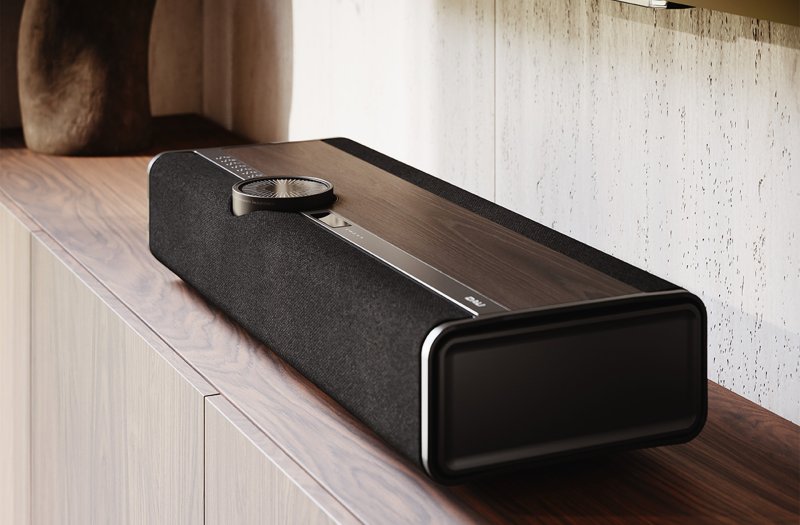 DALI VEGA Dark Oak on a sideboard, showing the end panel passive radiator