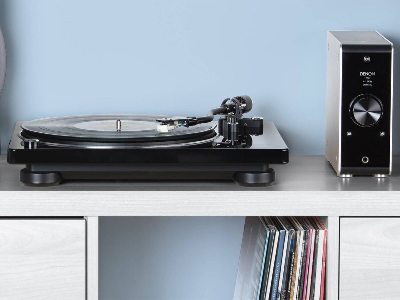 Denon DP-400 Turntable Black on shelf with vinyl records