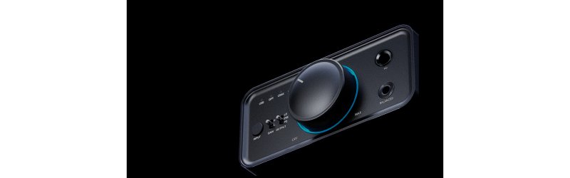 FiiO K7 chassis detail showing illuminated volume knob and headphone outputs