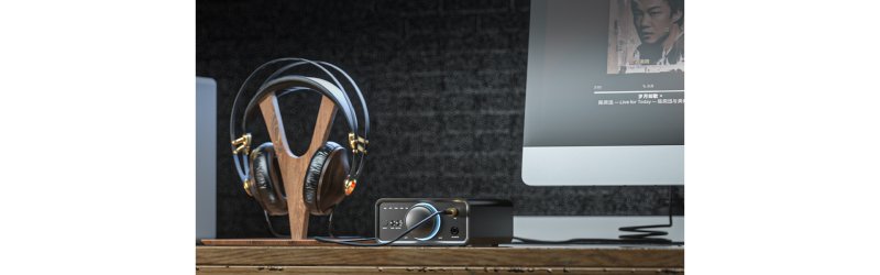 FiiO K7 in use with full-size headphones on a desk