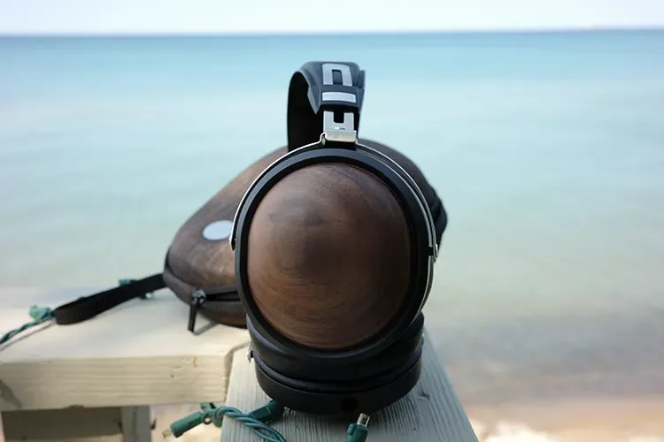 FiiO FT1 Black Walnut wood cups on bench beside the sea