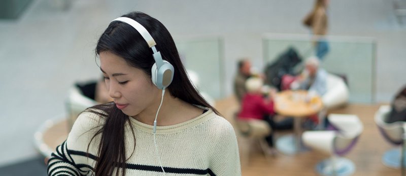 KEF M400 Hi-Fi On-Ear Headphones Champagne White — lifestyle shot showing headphones being worn