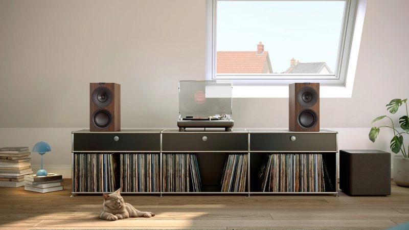 KEF Q Concerto Meta Standmount Speakers in a living room, Walnut finish shown