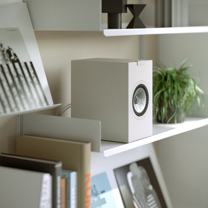 KEF Q1 Meta Bookshelf Speaker in a shelf setting, Satin White finish shown