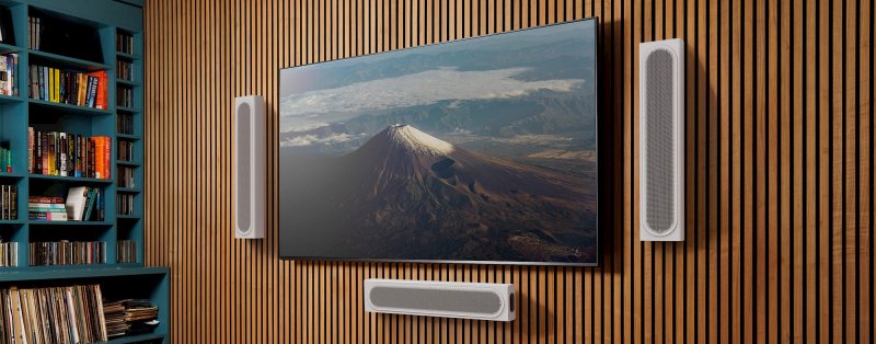 Monitor Audio Radius On-Wall 4G speakers in Satin White wall-mounted around a TV