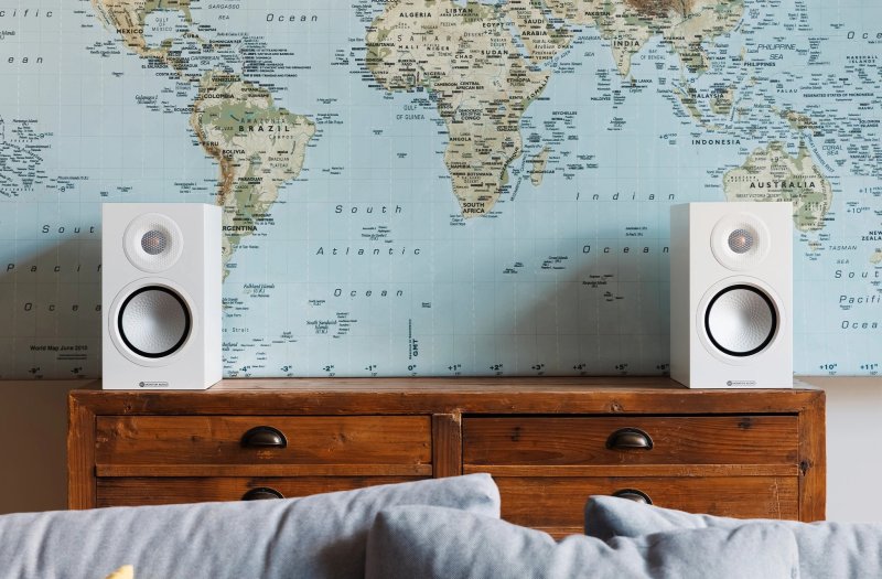 Monitor Audio Silver 100 8G Standmount Speakers Satin White (Pair) on a side table
