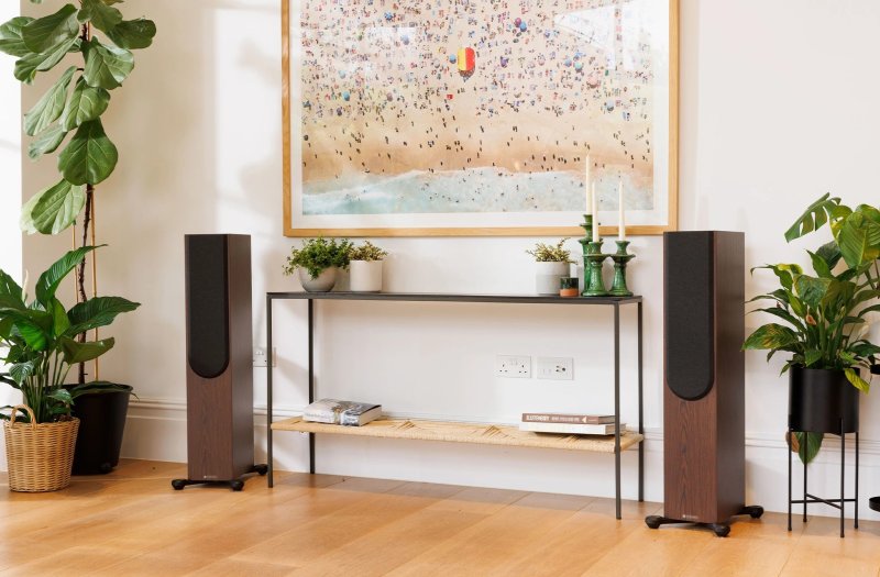 Monitor Audio Silver 300 8G European Walnut in a living room setting with grilles