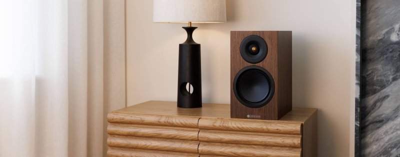 Monitor Audio Silver 50 8G in European Walnut shown on a sideboard in a living room setting