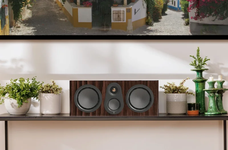 Monitor Audio Silver Centre 8G on a console in a living room, High Gloss Black finish shown
