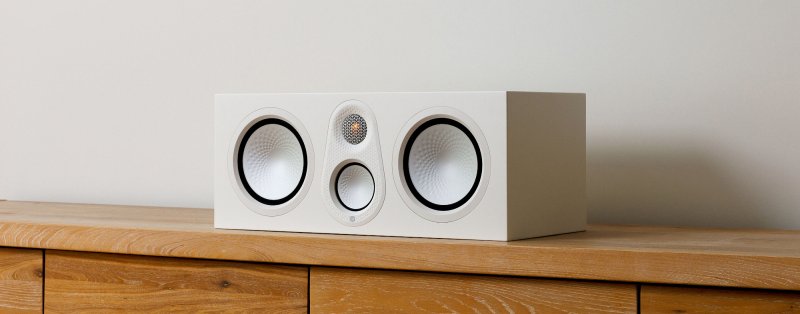 Monitor Audio Silver Centre 8G in Satin White on a wooden console