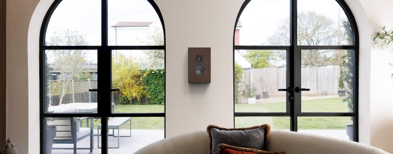 Monitor Audio Silver On-Wall 8G European Walnut wall mounted in a living room