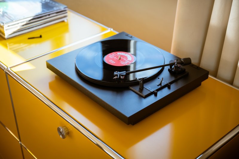 Pro-Ject A1.2 Black — lifestyle shot with vinyl record playing