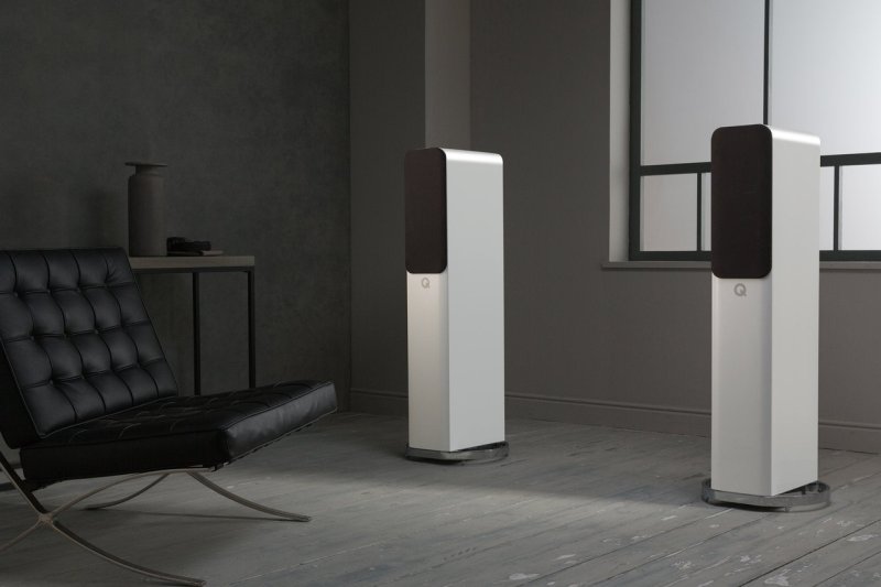 Q Acoustics Concept 500 in Gloss White & Light Oak — lifestyle setting showing pair with grilles in a modern living room