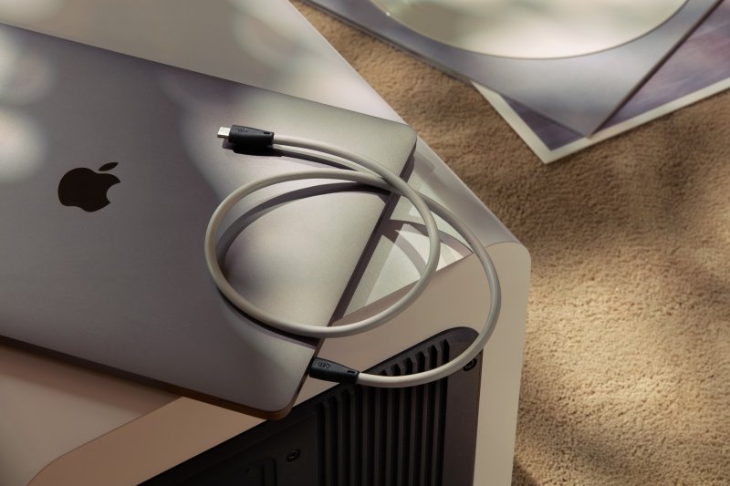 QED Performance USB-C to USB-C cable coiled on a laptop in a desktop audio setup