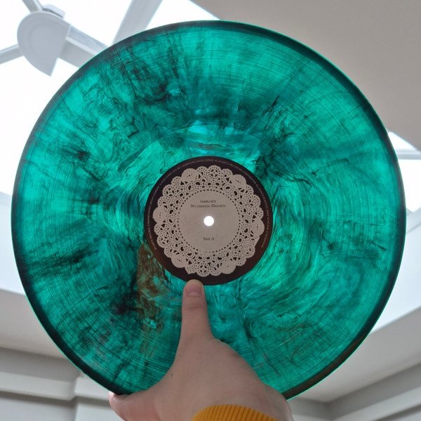 Green and black marbled vinyl LP held to the light